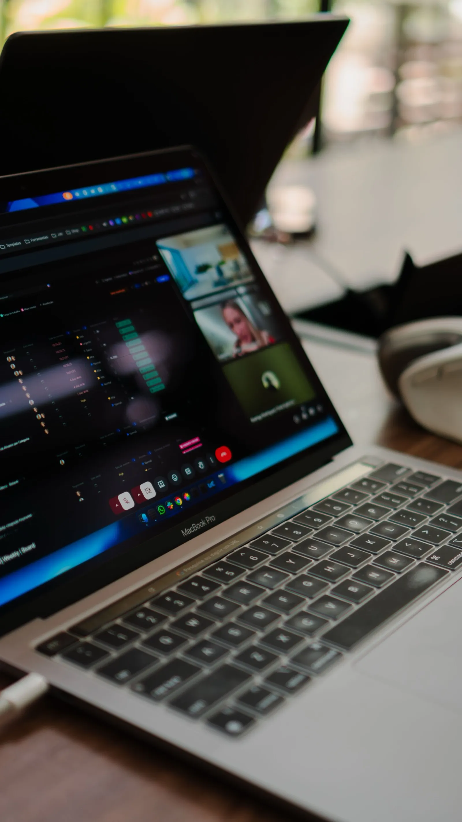 A laptop on a desk showing a dark dashboard